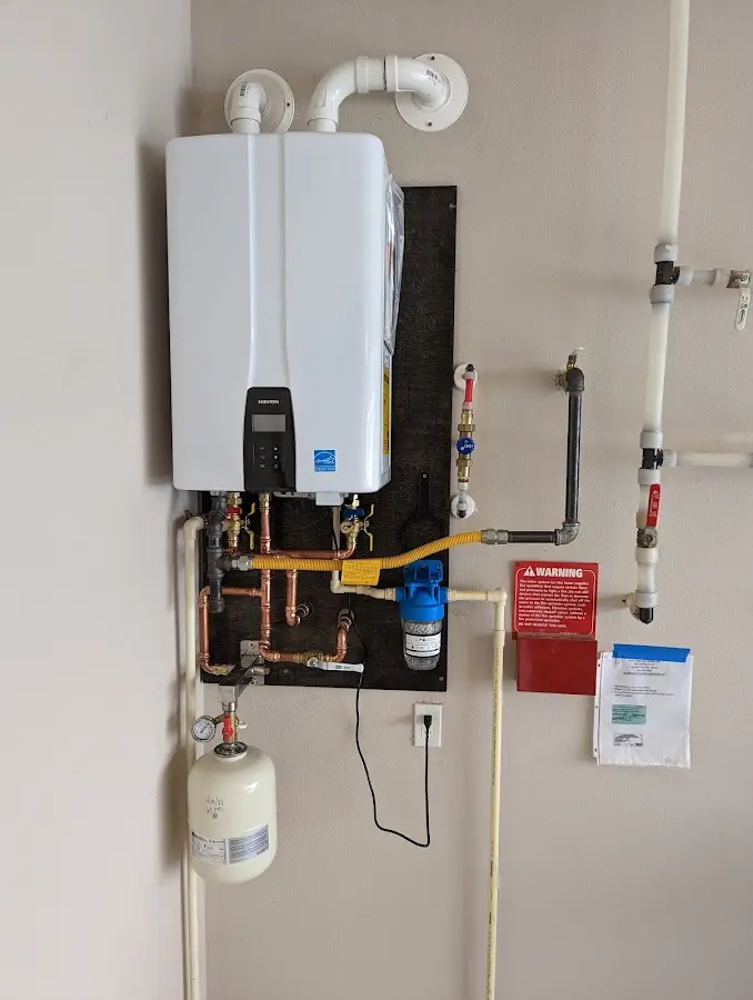 Professional plumber installing copper piping in a Lopatcong home